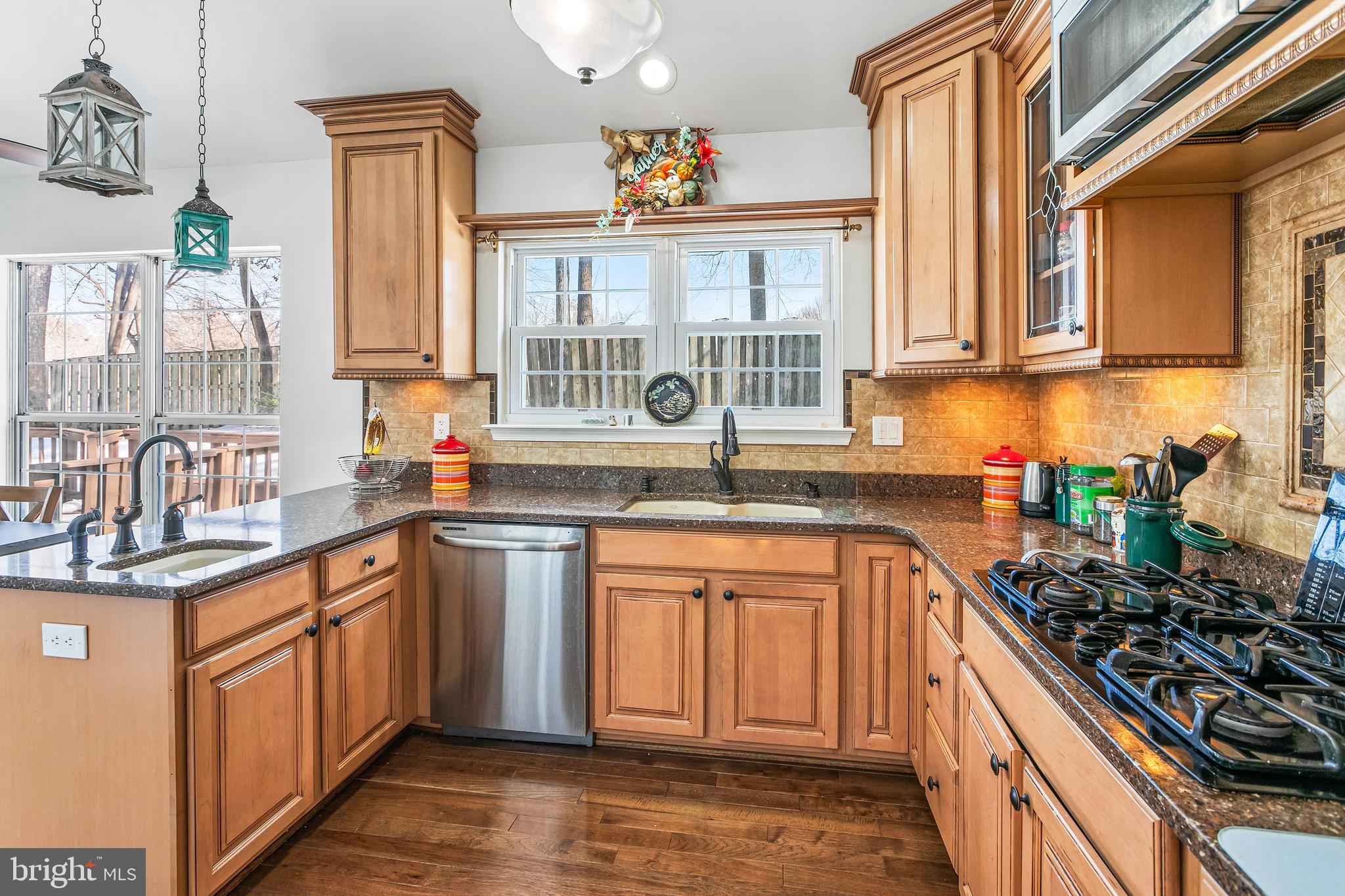 8217 Bayberry Ridge Road Fairfax Station, VA 22039 - Photo 7 of 35 a kitchen with stainless steel appliances a sink window and cabinets