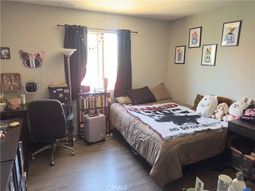 1204 Lilac Ridge Drive Perris, CA 92571 - Photo 11 of 14 a bedroom with a bed and a window