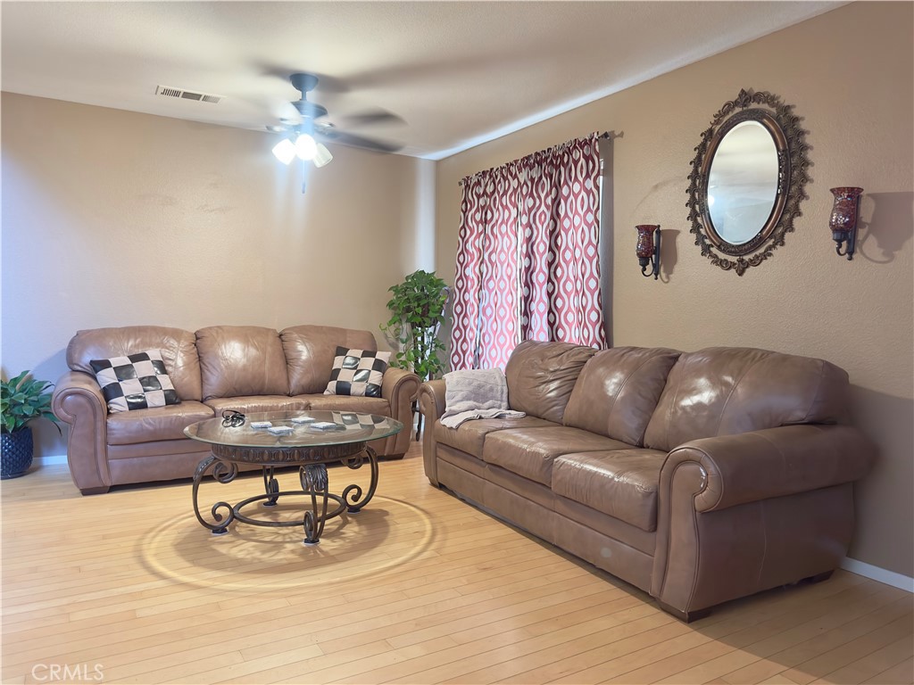 1204 Lilac Ridge Drive Perris, CA 92571 - Photo 3 of 14 a living room with furniture flowerpot and window