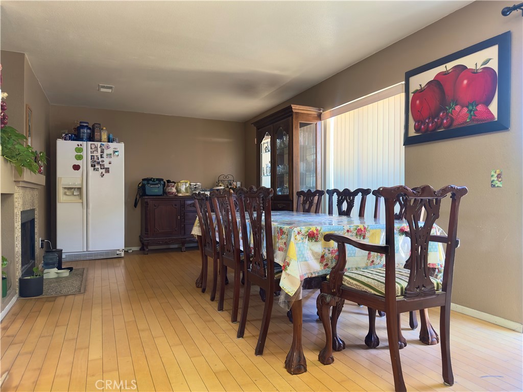 1204 Lilac Ridge Drive Perris, CA 92571 - Photo 5 of 14 a view of a dining room with furniture and wooden floor