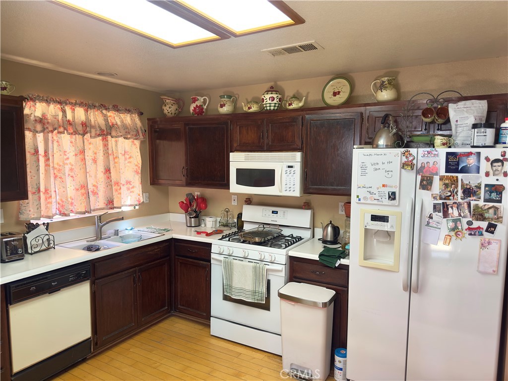 1204 Lilac Ridge Drive Perris, CA 92571 - Photo 6 of 14 a kitchen with stainless steel appliances a stove a sink and a refrigerator