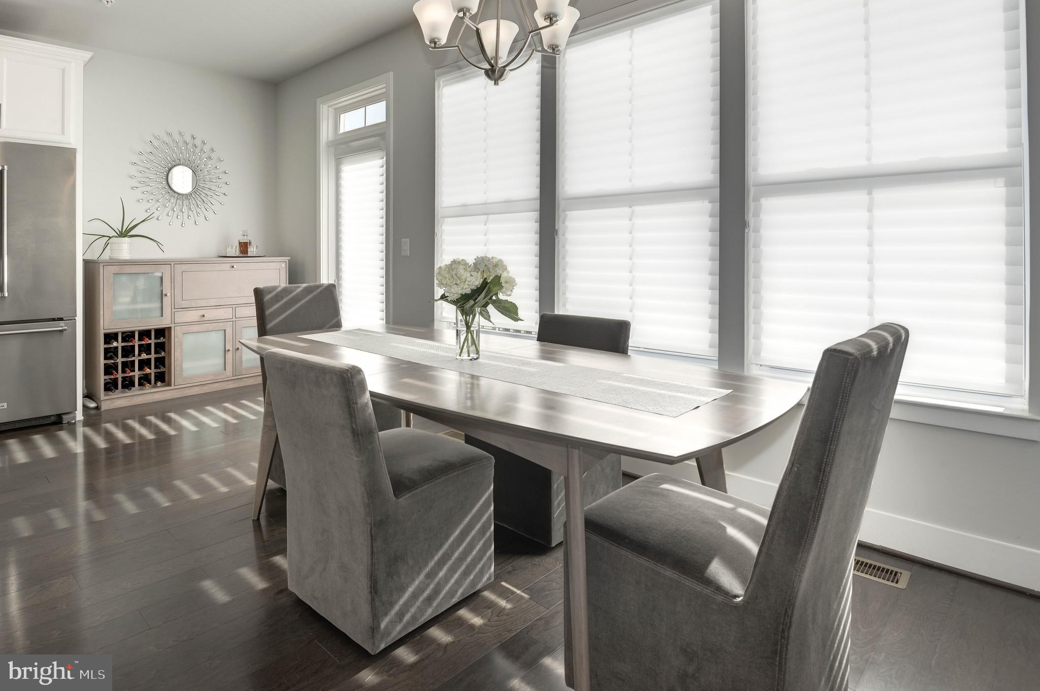 11689 Sunrise Square Place Reston, VA 20191 - Photo 10 of 46 DINING AREA WITH A WALL OF WINDOWS