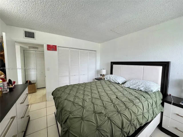 a bedroom with a bed and a mirror