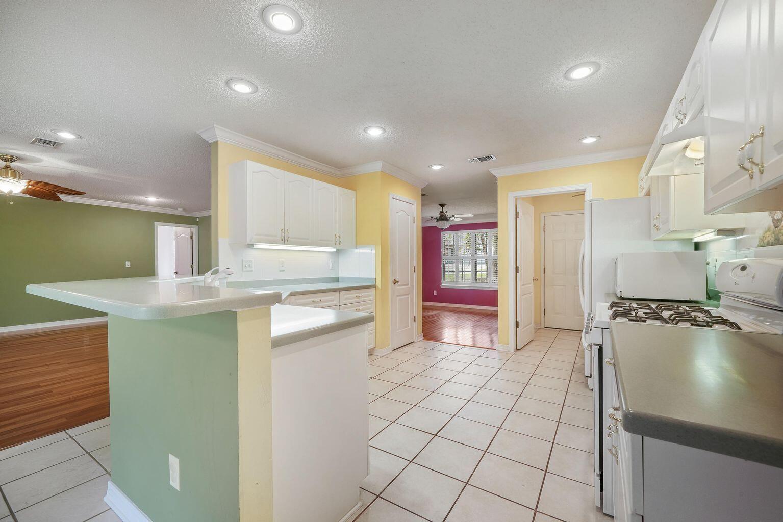720 Riva Ridge Drive Crestview, FL 32539 - Photo 14 of 36 a kitchen with stainless steel appliances granite countertop a sink and cabinets