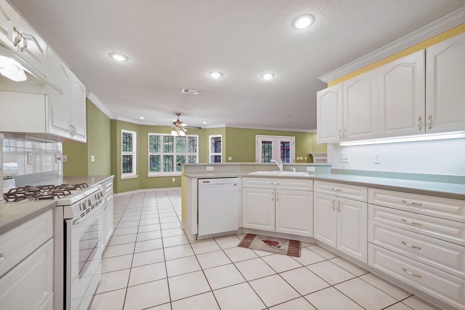 720 Riva Ridge Drive Crestview, FL 32539 - Photo 15 of 36 a kitchen with cabinets and chairs