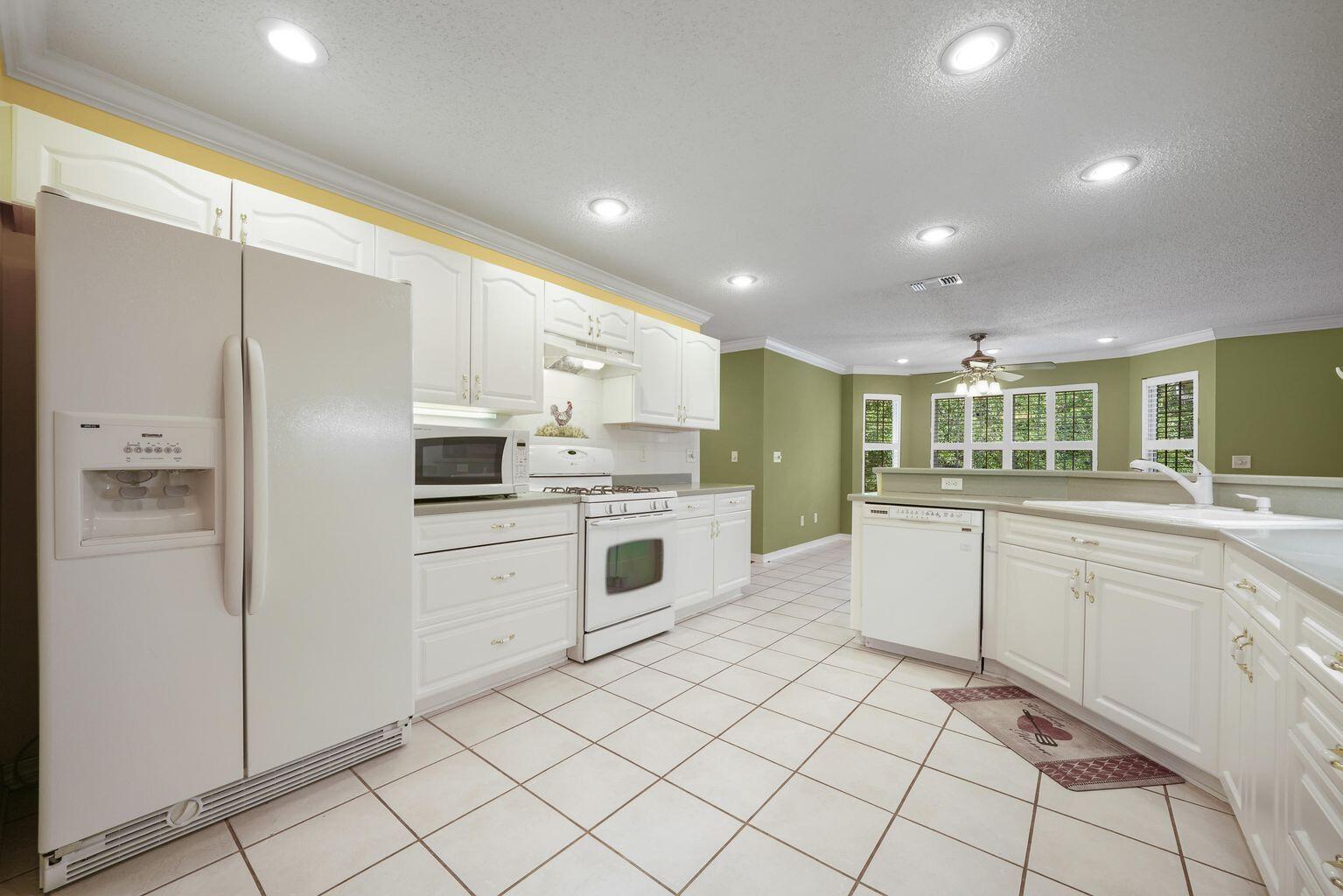 720 Riva Ridge Drive Crestview, FL 32539 - Photo 16 of 36 a kitchen with white cabinets and white appliances
