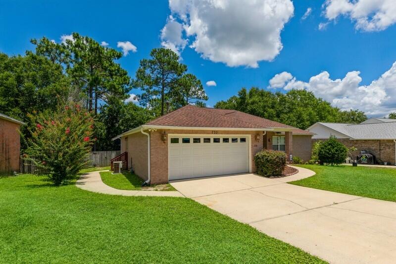 720 Riva Ridge Drive Crestview, FL 32539 - Photo 2 of 36 a front view of a house with garden