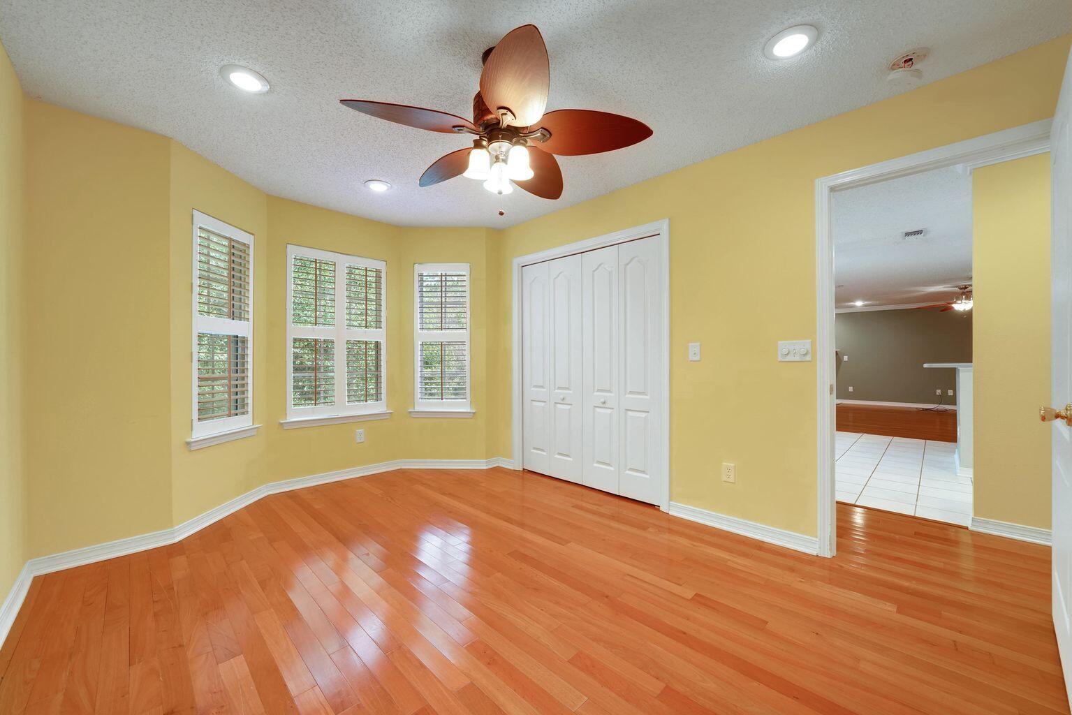 720 Riva Ridge Drive Crestview, FL 32539 - Photo 24 of 36 a view of an empty room with wooden floor and a window