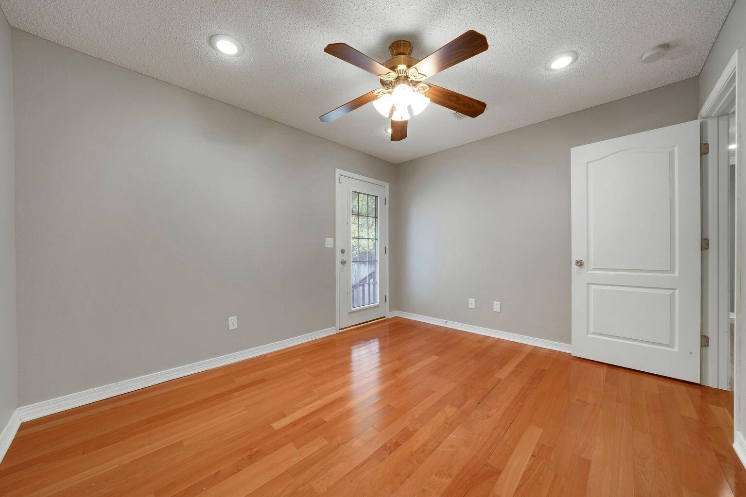 720 Riva Ridge Drive Crestview, FL 32539 - Photo 26 of 36 an empty room with wooden floor and windows
