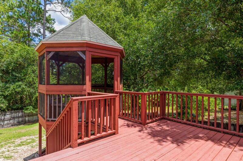 720 Riva Ridge Drive Crestview, FL 32539 - Photo 31 of 36 a view of a wooden deck with a yard