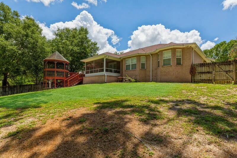 720 Riva Ridge Drive Crestview, FL 32539 - Photo 36 of 36 a front view of a house with a yard and trees