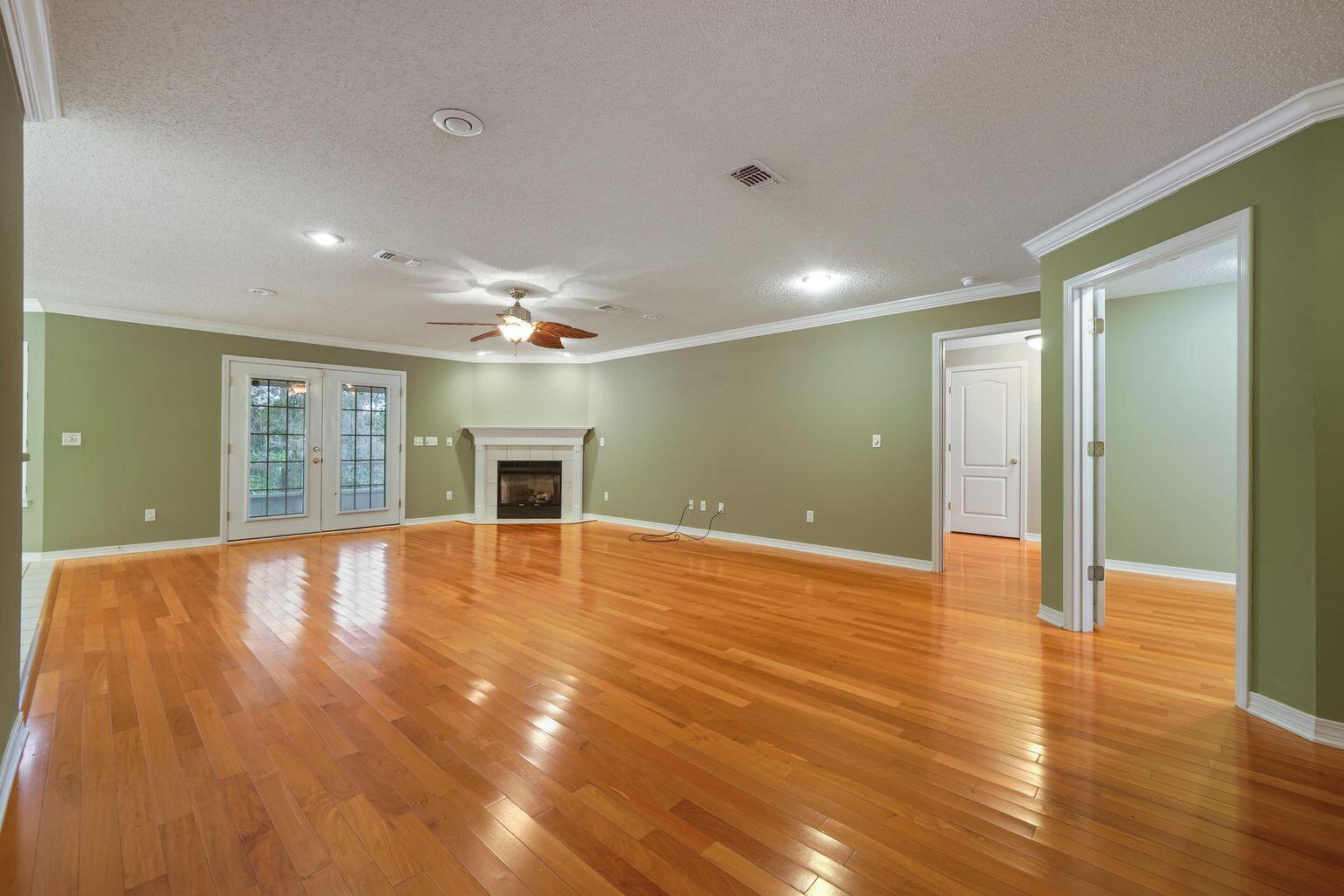 720 Riva Ridge Drive Crestview, FL 32539 - Photo 5 of 36 a view of an empty room with wooden floor and a window