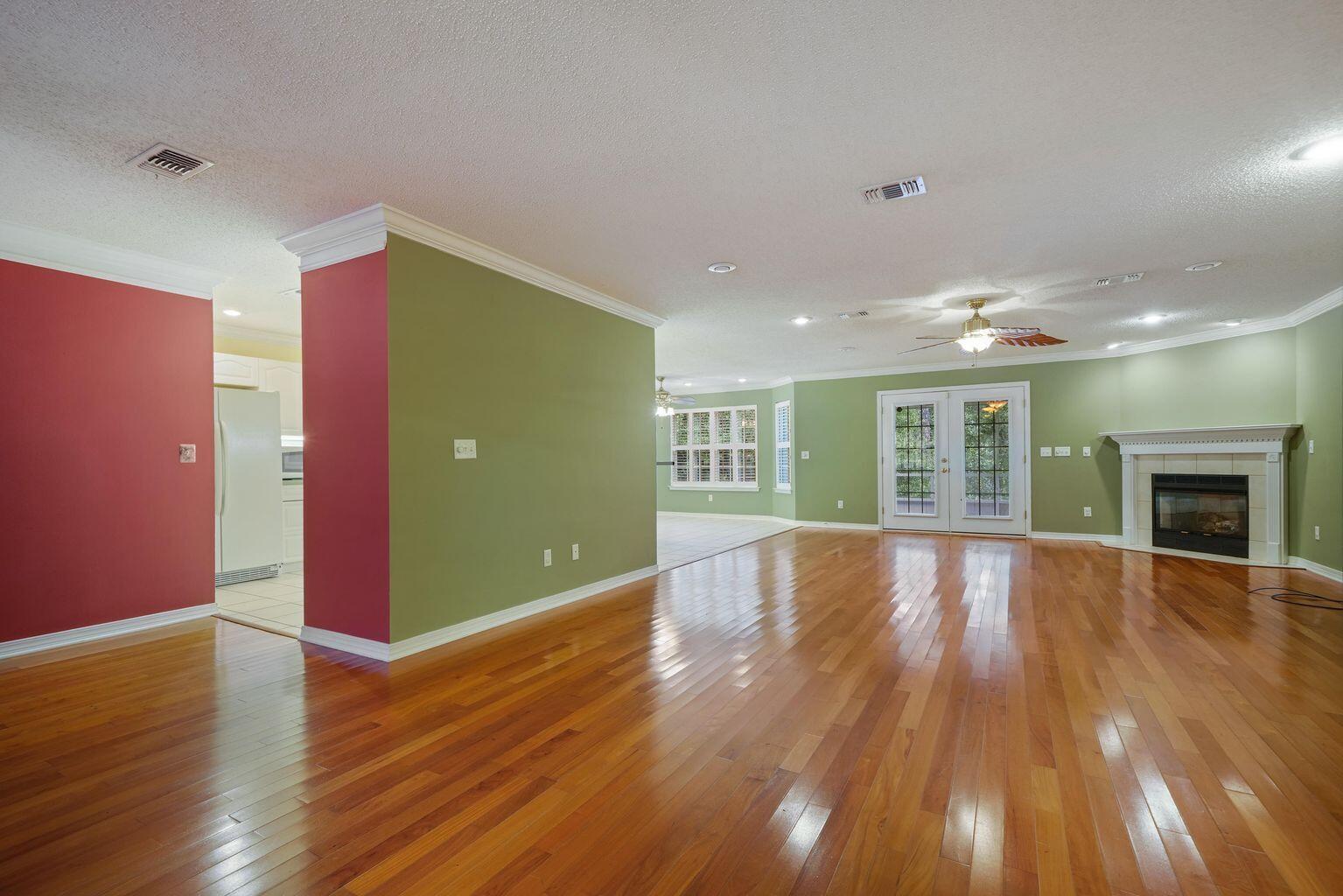720 Riva Ridge Drive Crestview, FL 32539 - Photo 6 of 36 a view of an empty room with wooden floor and a fireplace