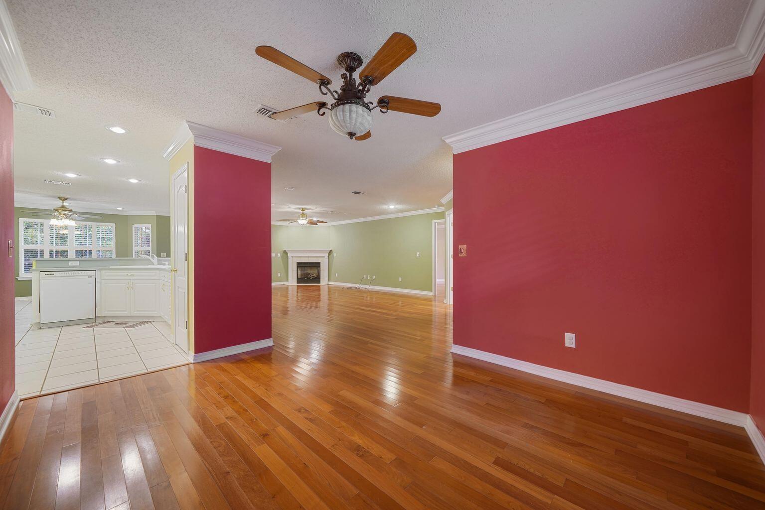 720 Riva Ridge Drive Crestview, FL 32539 - Photo 7 of 36 a view of a livingroom with a furniture floor to ceiling window and wooden floor