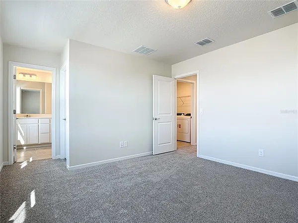 an empty room with a bathroom and a sink