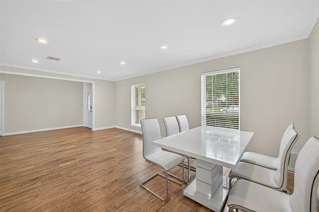 a view of a dining room with furniture and wooden floor