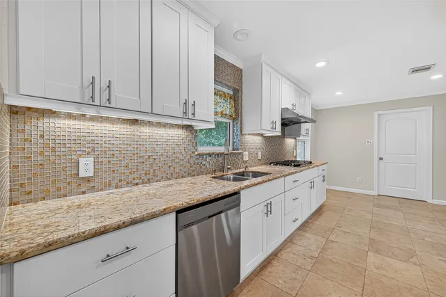 a kitchen that has a sink and a stove