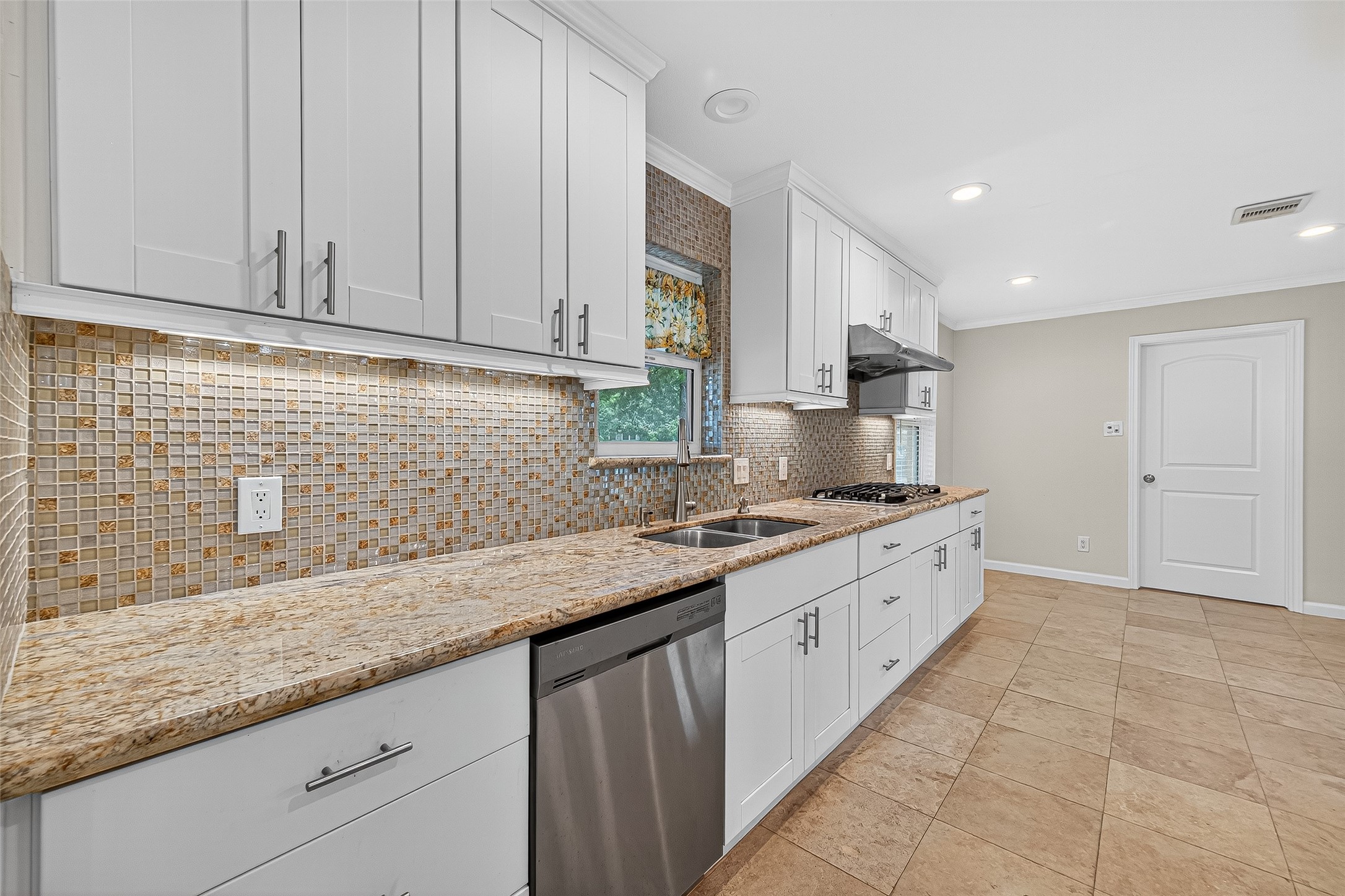 8530 Roos Road Houston, TX 77036 - Photo 17 of 43 a kitchen that has a sink and a stove