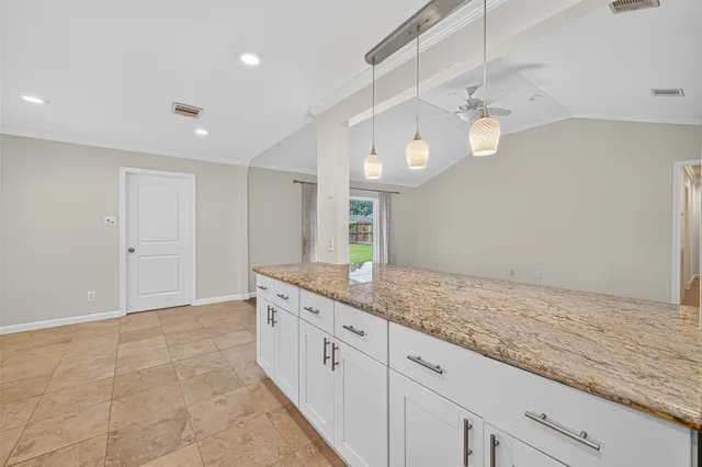 a bathroom with a granite countertop sink a light fixture and a mirror