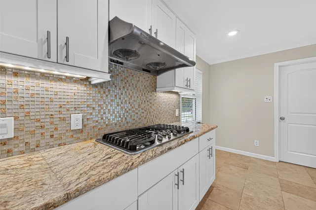 a kitchen with stainless steel appliances granite countertop a stove and a sink