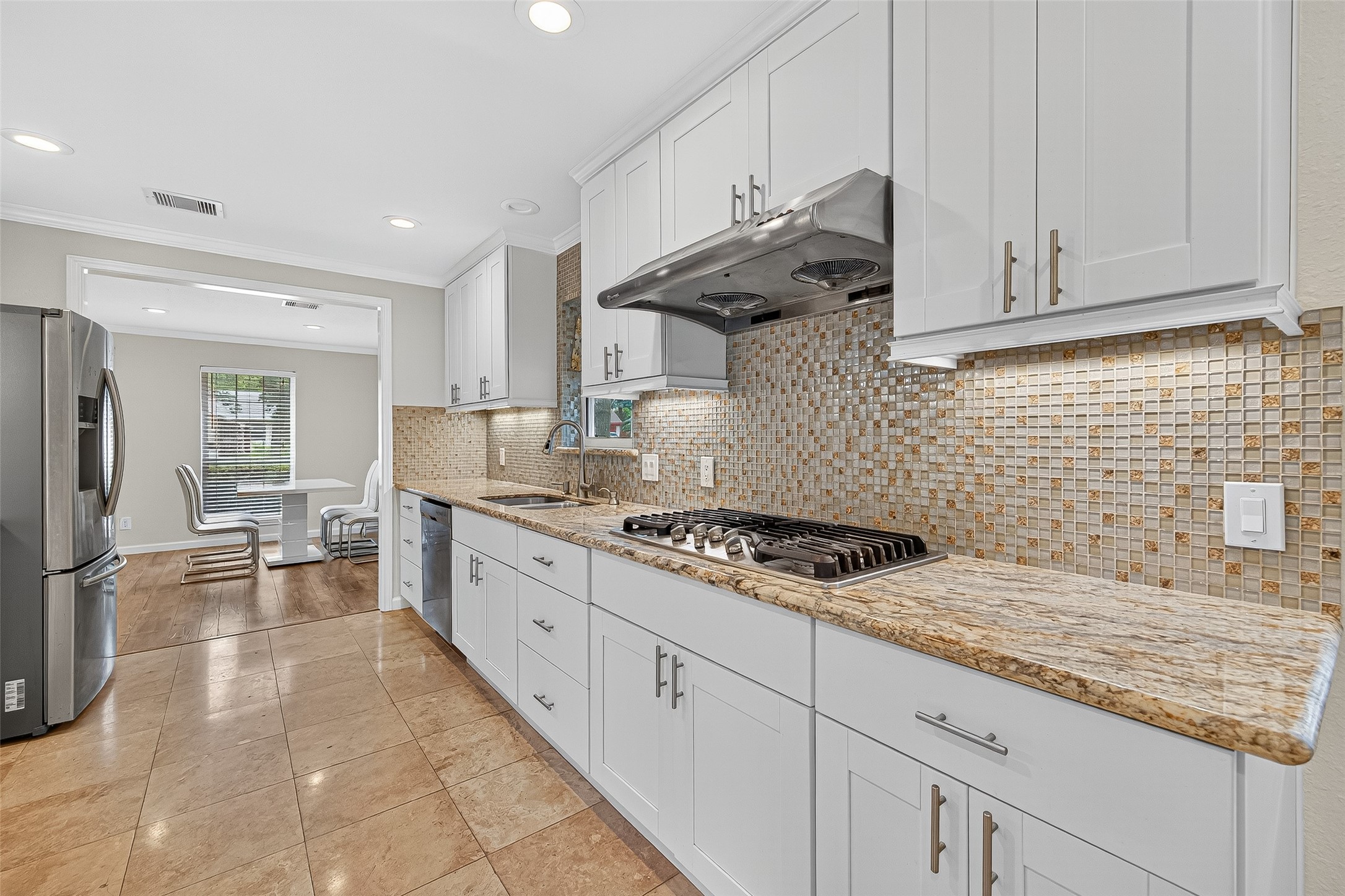 8530 Roos Road Houston, TX 77036 - Photo 21 of 43 a kitchen with granite countertop a stove a sink dishwasher and a refrigerator