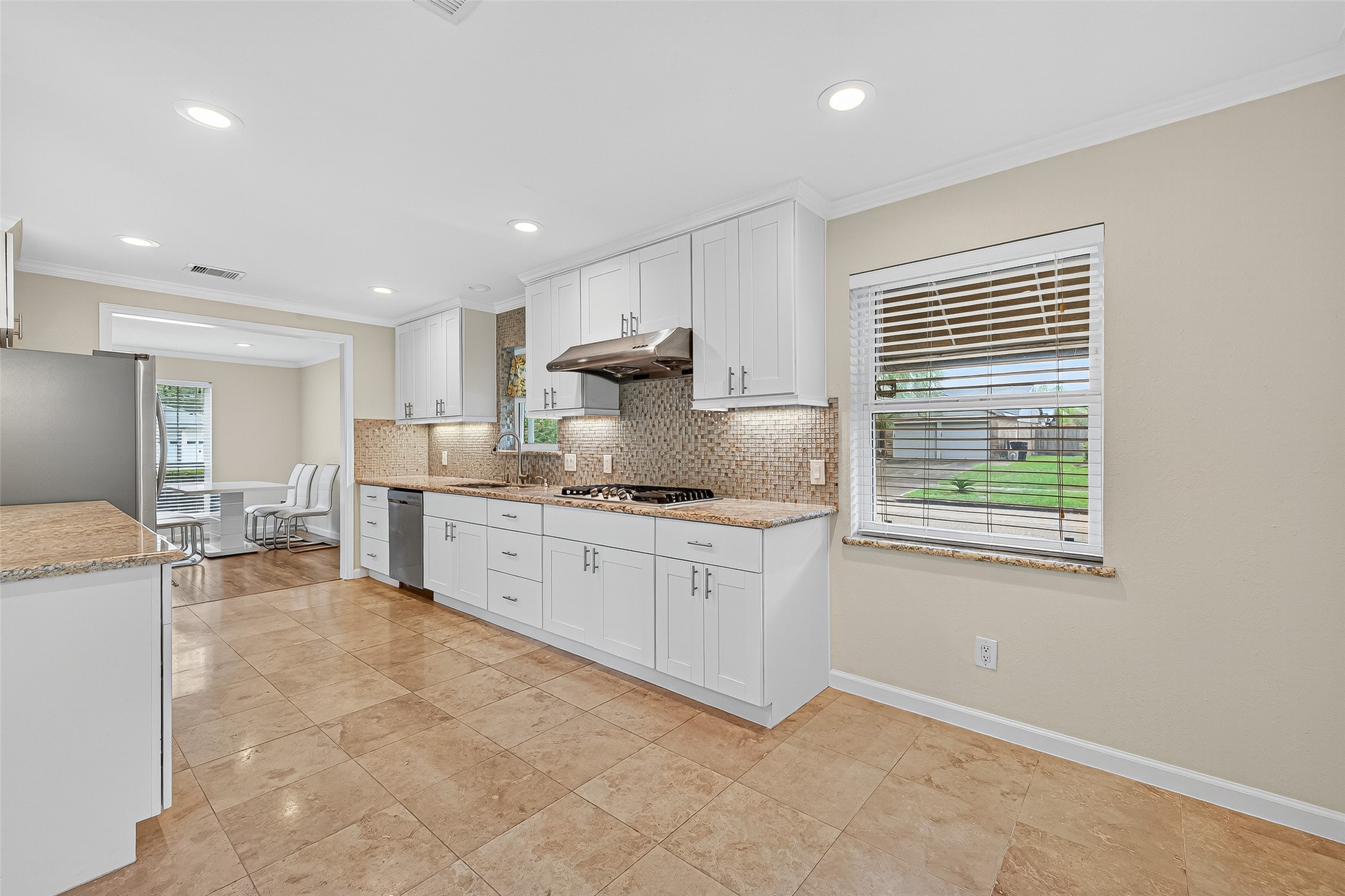 8530 Roos Road Houston, TX 77036 - Photo 24 of 43 a kitchen with a sink window and cabinets