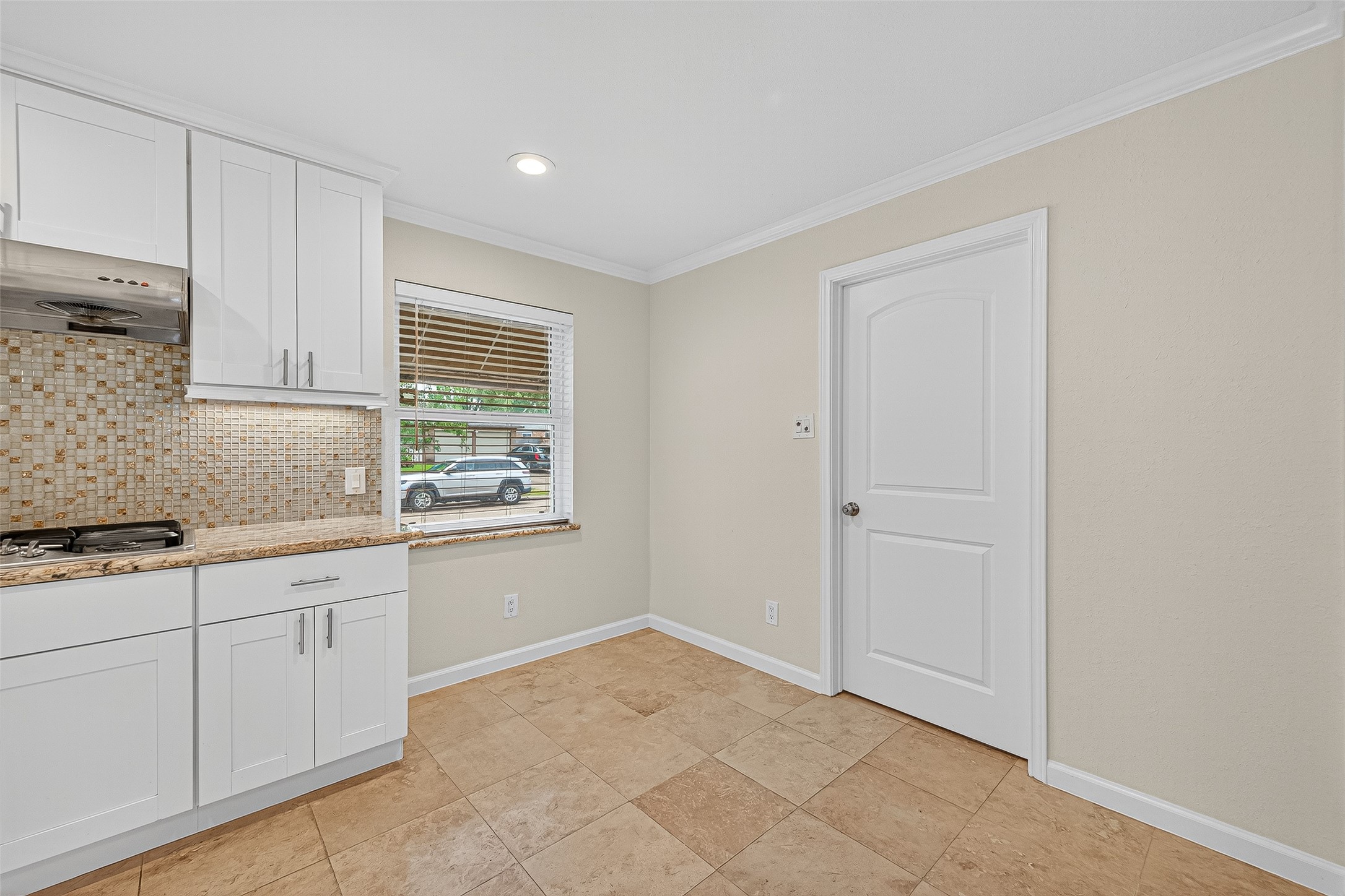 8530 Roos Road Houston, TX 77036 - Photo 25 of 43 a kitchen with white cabinets and a window