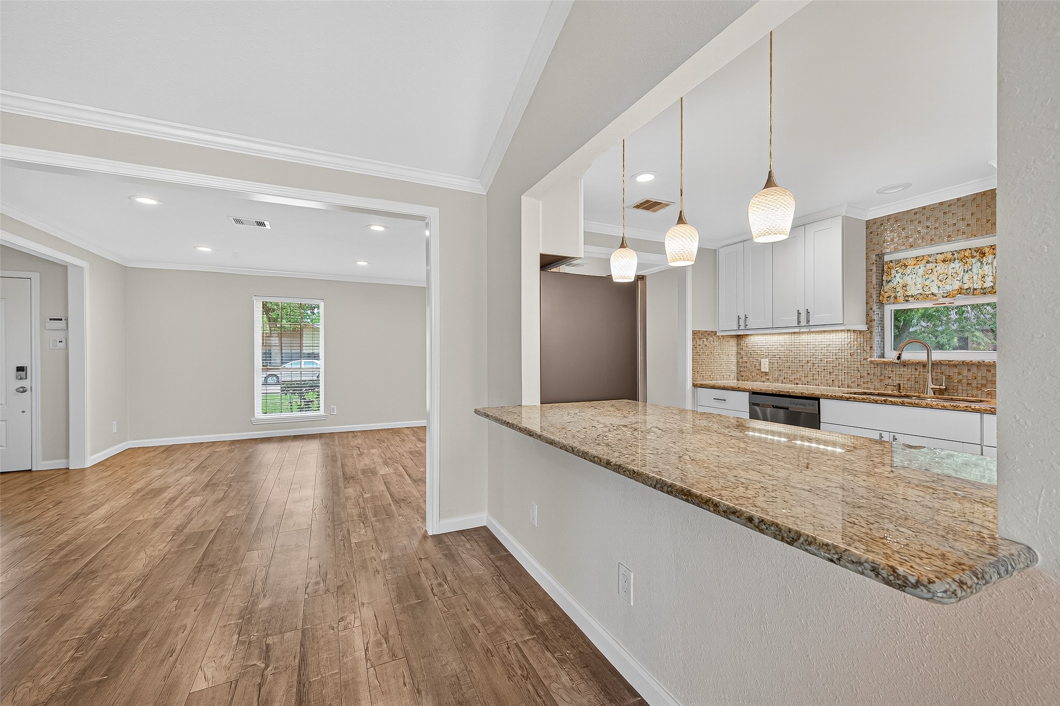 8530 Roos Road Houston, TX 77036 - Photo 26 of 43 a view of a kitchen counter space and wooden floor