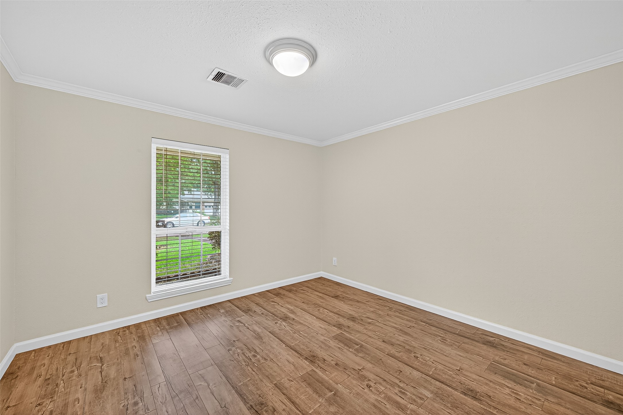 8530 Roos Road Houston, TX 77036 - Photo 29 of 43 an empty room with wooden floor and windows