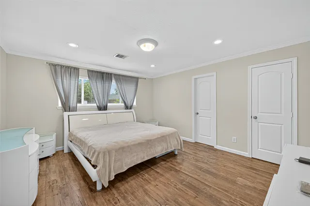 a bedroom with a bed and a large window