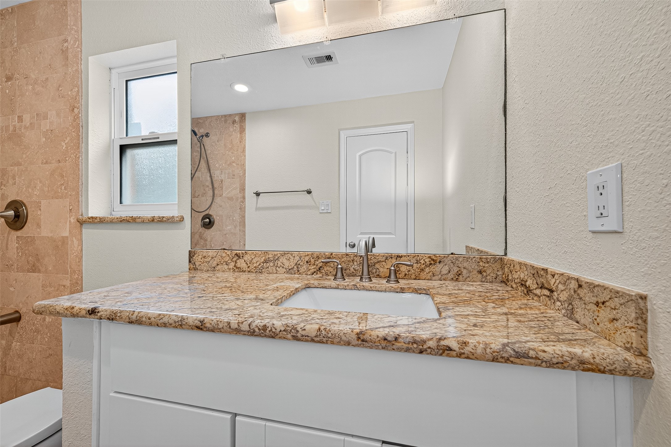 8530 Roos Road Houston, TX 77036 - Photo 35 of 43 a bathroom with a granite countertop sink and a mirror