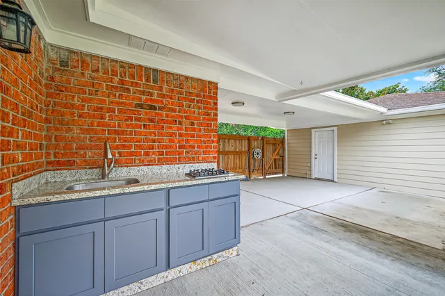 a bathroom with a granite countertop sink and a shower