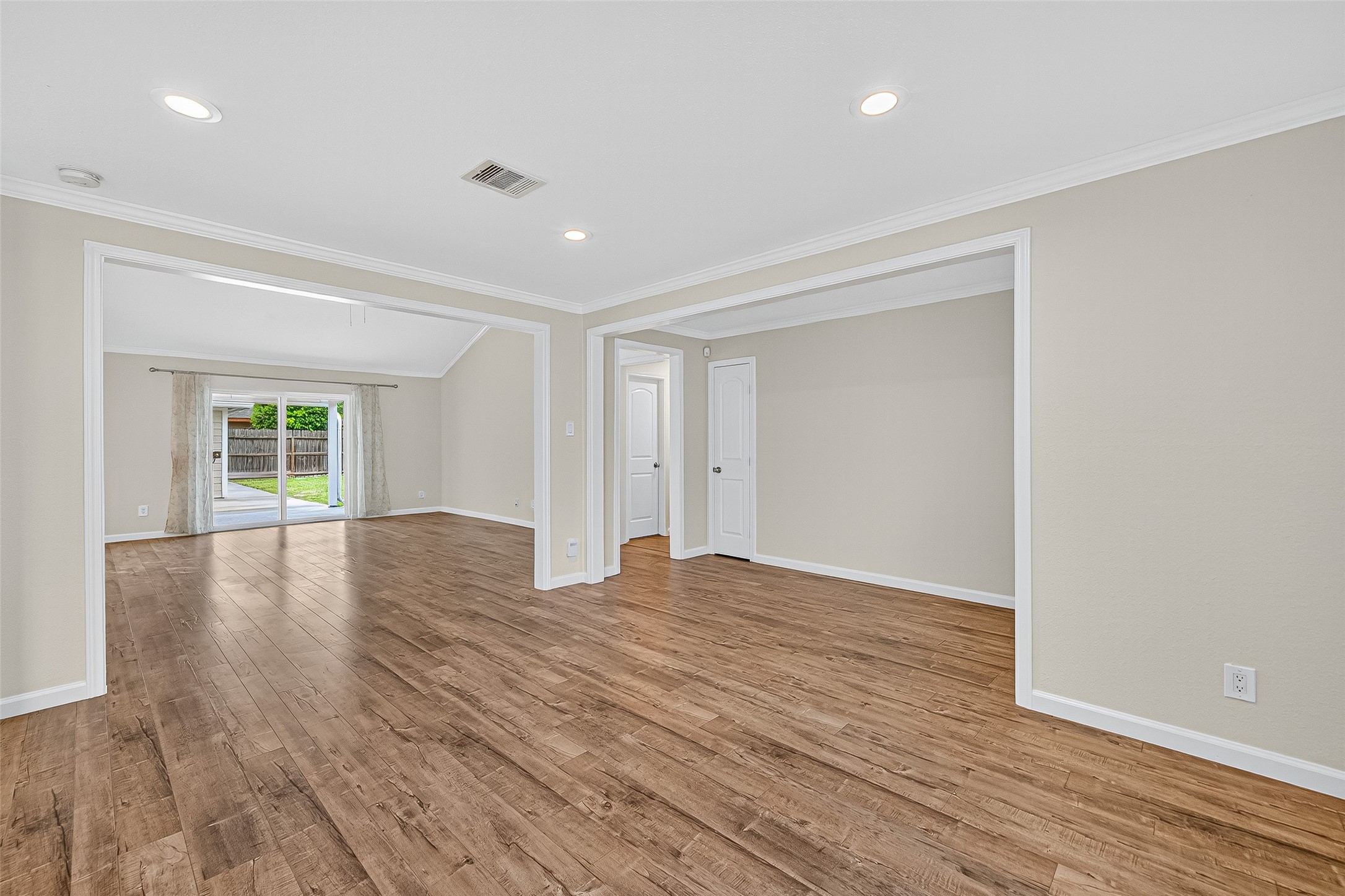 8530 Roos Road Houston, TX 77036 - Photo 7 of 43 a view of empty room with wooden floor and fan