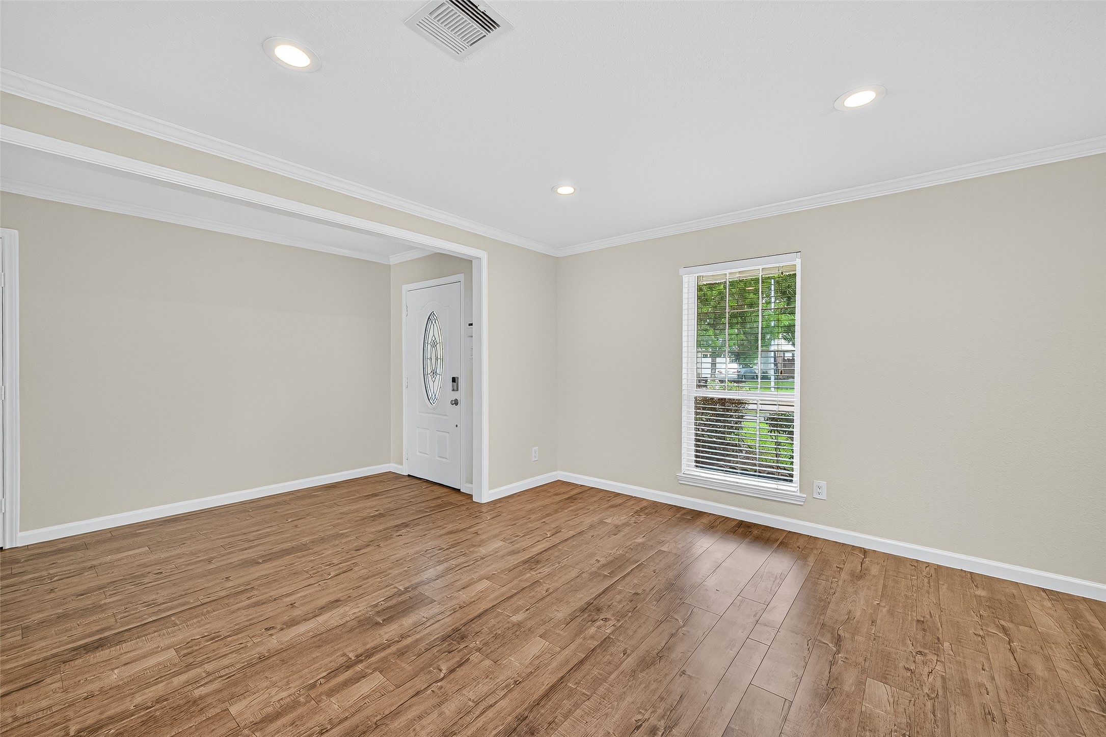 8530 Roos Road Houston, TX 77036 - Photo 8 of 43 an empty room with wooden floor and windows