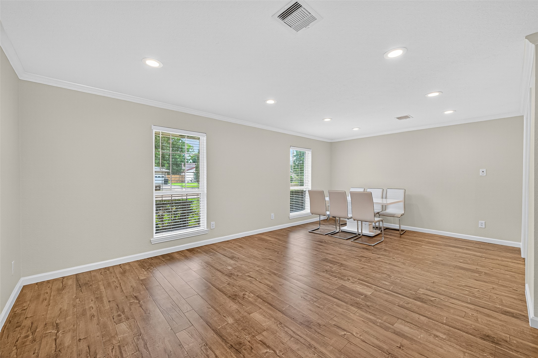 8530 Roos Road Houston, TX 77036 - Photo 9 of 43 a view of an empty room with wooden floor and a window