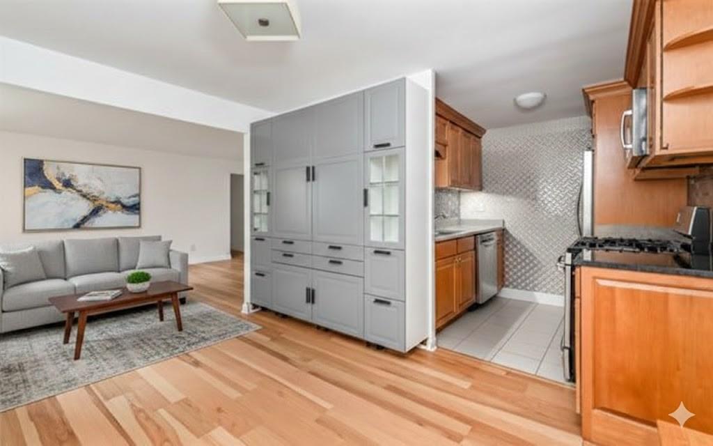 4601 Fifth Avenue, Unit 322 Pittsburgh, PA 15213 - Photo 14 of 27 a kitchen with stainless steel appliances kitchen island wooden cabinets and center island