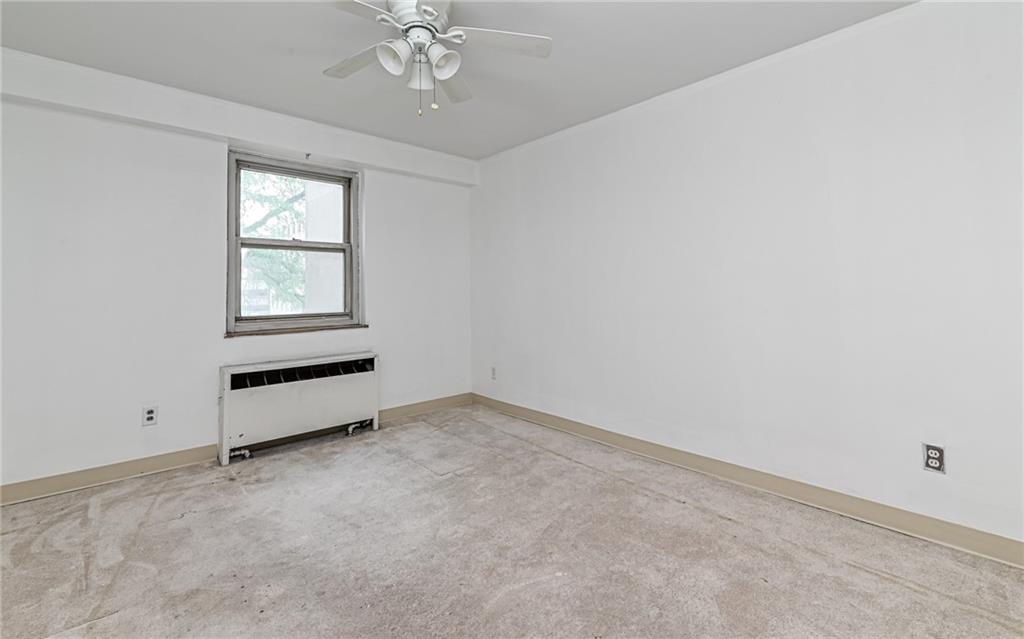 4601 Fifth Avenue, Unit 322 Pittsburgh, PA 15213 - Photo 15 of 18 an empty room with chandelier fan and windows