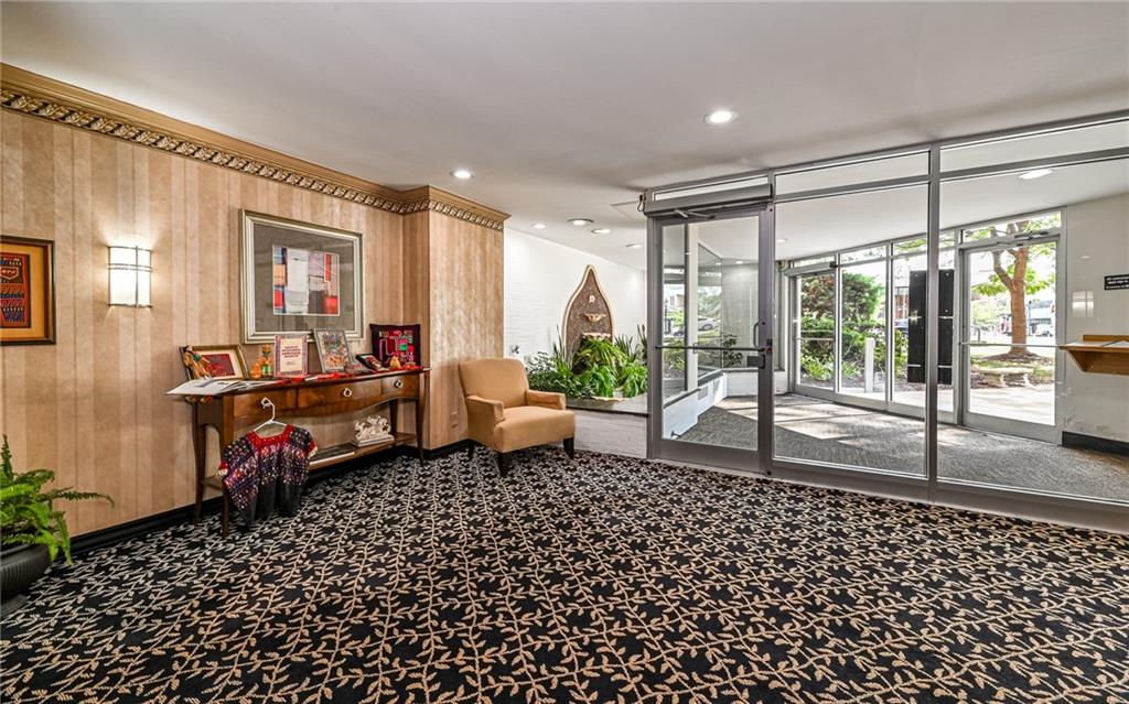 4601 Fifth Avenue, Unit 322 Pittsburgh, PA 15213 - Photo 3 of 18 a living room with a black couch next to a window