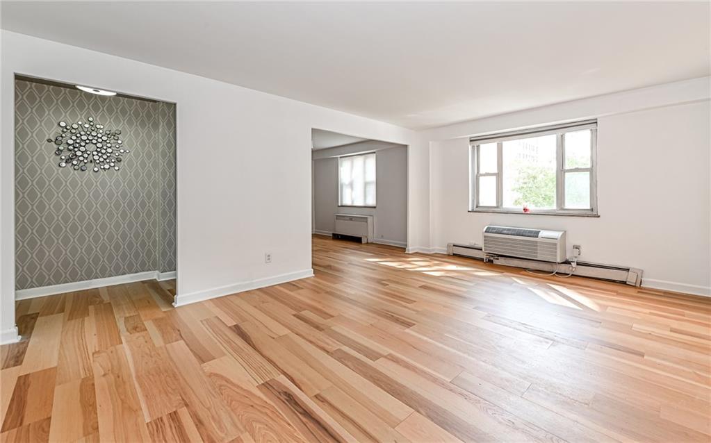 4601 Fifth Avenue, Unit 322 Pittsburgh, PA 15213 - Photo 5 of 18 an empty room with wooden floor and windows