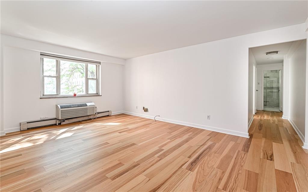 4601 Fifth Avenue, Unit 322 Pittsburgh, PA 15213 - Photo 6 of 18 a view of empty room with wooden floor and fan