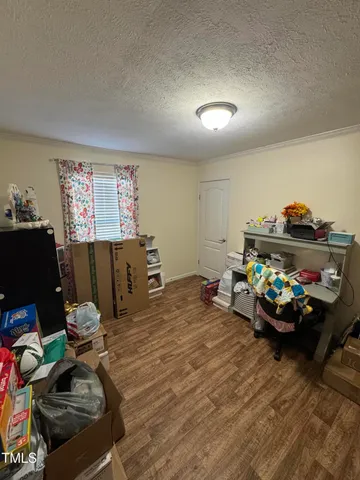 a bedroom with furniture and a wooden floor