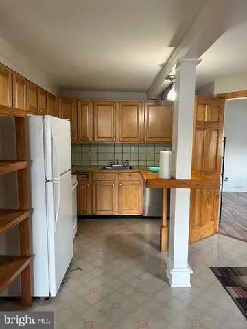 a kitchen with stainless steel appliances a refrigerator and a sink