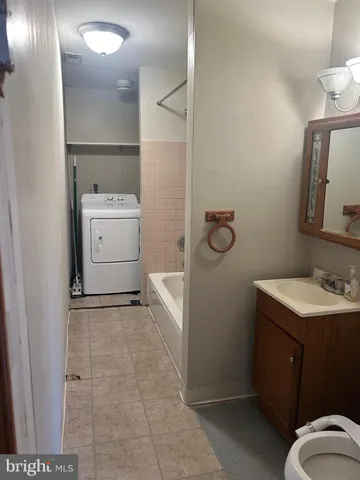 a bathroom with a sink toilet and mirror