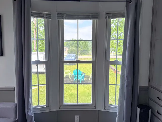 a view of an empty room with large windows