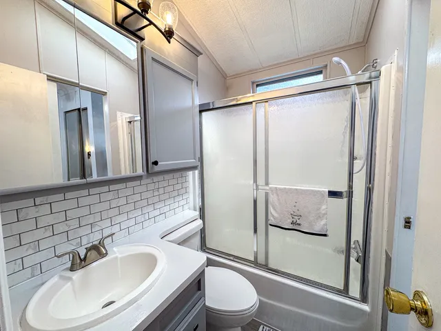 a bathroom with a sink toilet and shower
