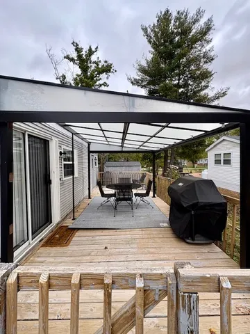 a view of a patio with table and chairs under an umbrella with a table