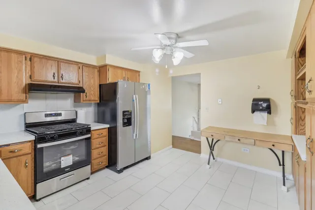 a kitchen with stainless steel appliances a stove a refrigerator and cabinets
