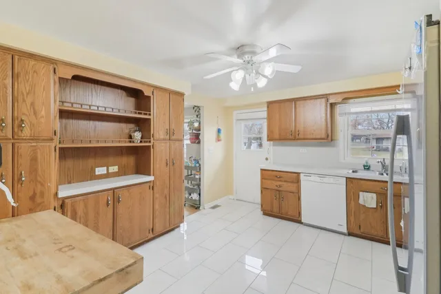 a large kitchen with cabinets and wooden floor