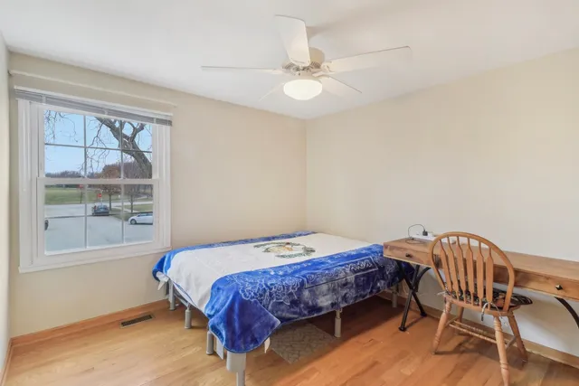 a bedroom with a bed a table and chair