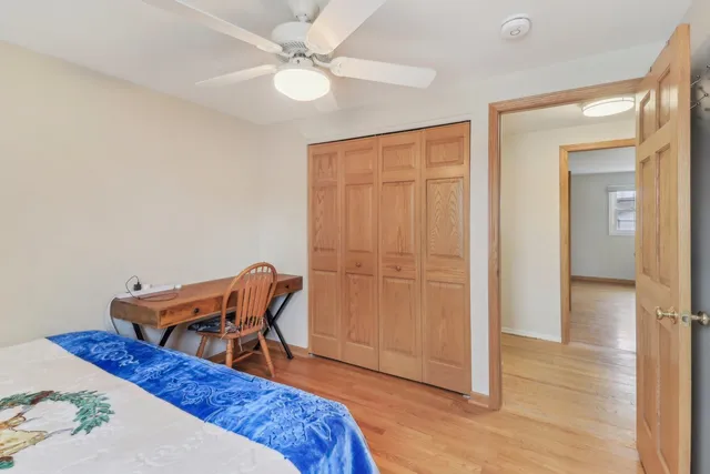 a bed room with a bed and a chair